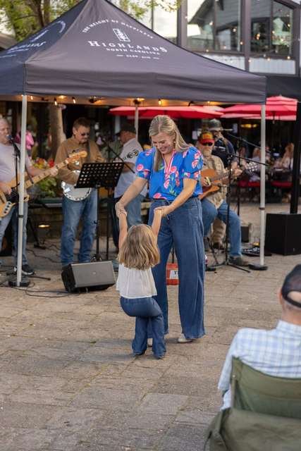 Rachel Wavra dancing with her daughter at a Highlands street festival