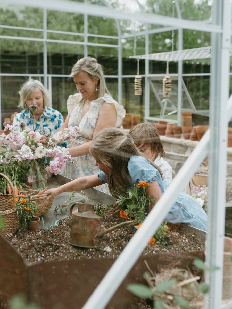 Rachel Wavra gardening with family, cutting fresh flowers in the greenhouse