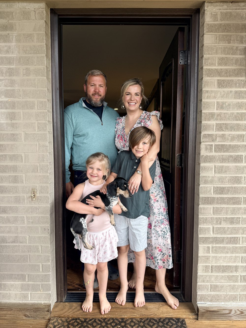 Rachel Wavra with her husband Tyler and kids Livi and Jackson at their front door